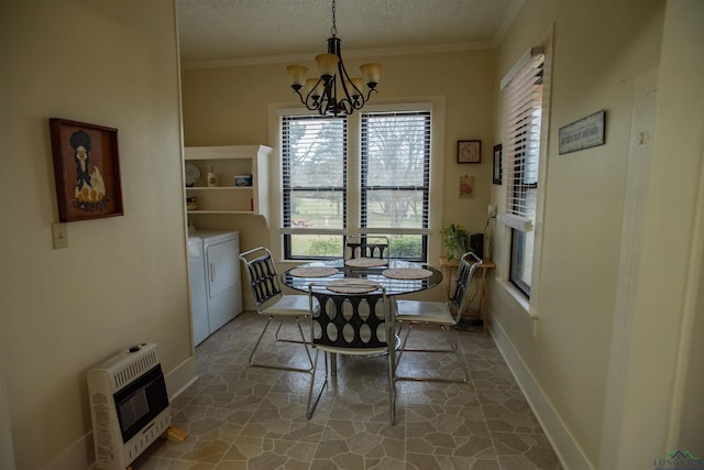 dining space featuring a textured ceiling, heating unit, crown molding, a chandelier, and independent washer and dryer