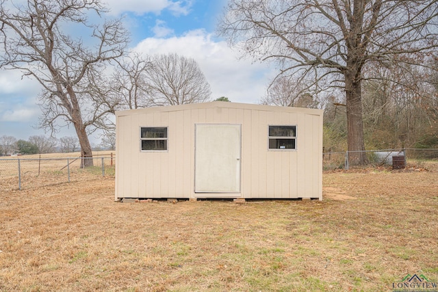 view of outbuilding featuring a lawn