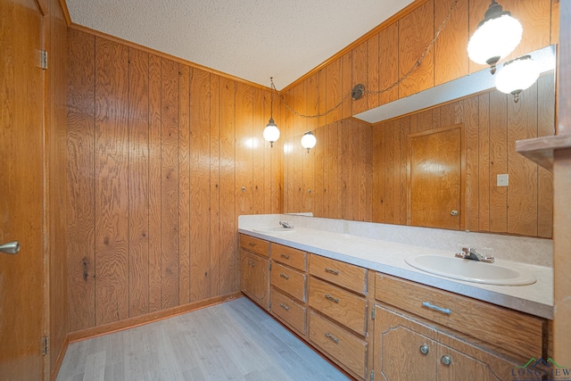 bathroom with wood-type flooring, vanity, and wood walls