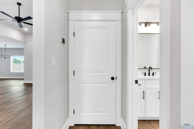 1513 Wellington Ln, Longview, TX 75605 - corridor with a sink, wood finished floors, and baseboards