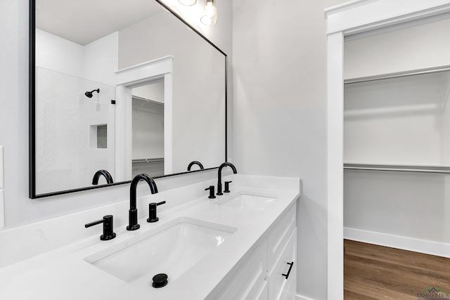 1513 Wellington Ln, Longview, TX 75605 - full bath featuring a walk in closet, double vanity, wood finished floors, a shower, and baseboards