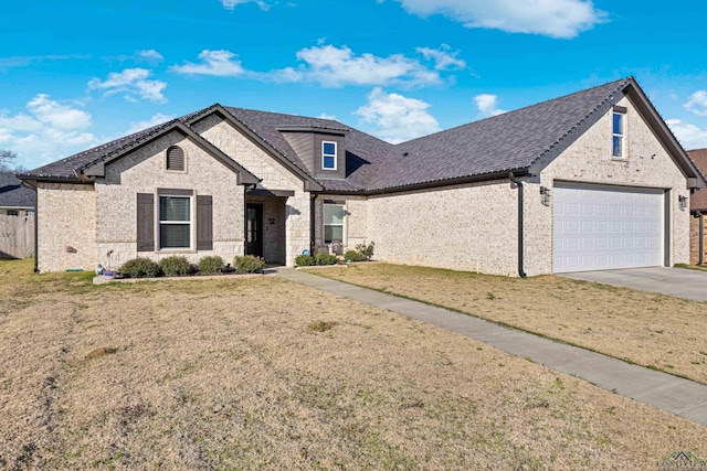 view of front of property with a garage and a front lawn