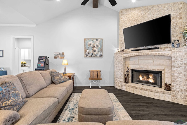 living room featuring vaulted ceiling with beams, ceiling fan, dark hardwood / wood-style flooring, and a fireplace