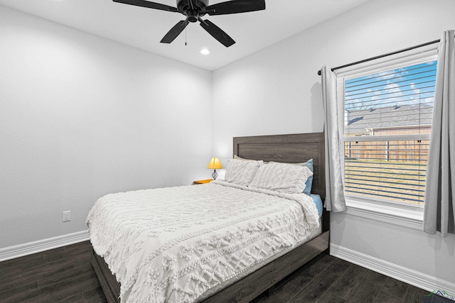 bedroom with dark hardwood / wood-style floors and ceiling fan