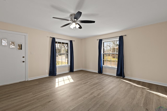 unfurnished room with hardwood / wood-style floors and ceiling fan