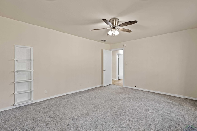 spare room with ceiling fan and light colored carpet