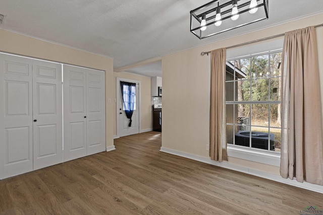 interior space with hardwood / wood-style flooring and a textured ceiling