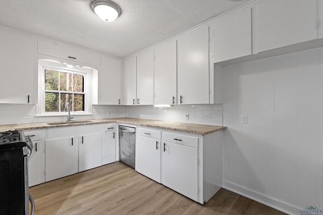 kitchen with sink, stainless steel range with gas cooktop, white cabinetry, a textured ceiling, and light hardwood / wood-style floors