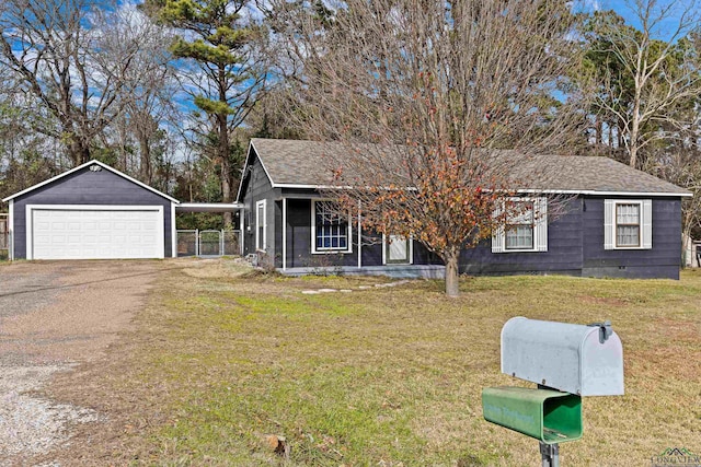 view of front of house with an outbuilding, a front lawn, and a garage