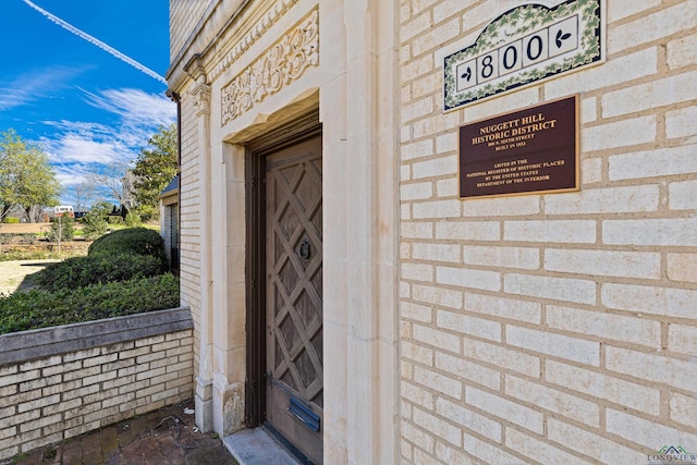 property entrance with brick siding