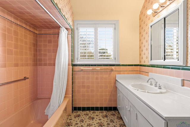 full bath with a healthy amount of sunlight, shower / bath combo, tile walls, and wainscoting