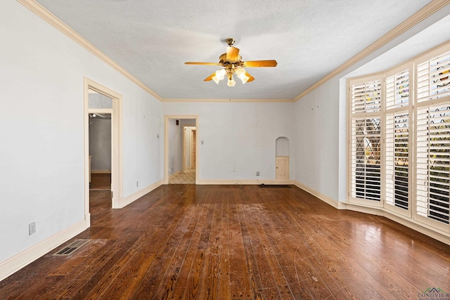 empty room with visible vents, arched walkways, wood-type flooring, ceiling fan, and a textured ceiling