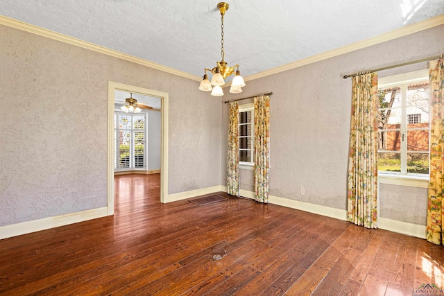 empty room with a textured wall, crown molding, baseboards, hardwood / wood-style floors, and an inviting chandelier