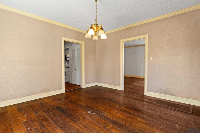 empty room with baseboards, hardwood / wood-style flooring, ornamental molding, an inviting chandelier, and a textured ceiling