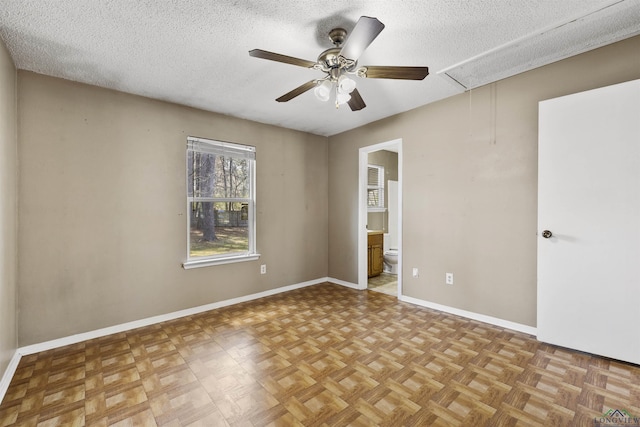 1324 Annette Dr, Longview, TX 75604 - empty room with attic access, a ceiling fan, a textured ceiling, and baseboards