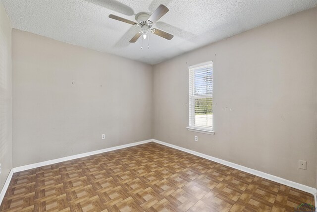 1324 Annette Dr, Longview, TX 75604 - empty room featuring a textured ceiling, ceiling fan, and baseboards