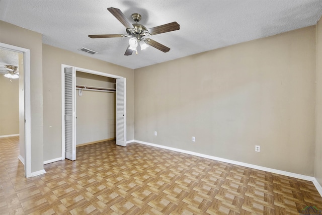 1324 Annette Dr, Longview, TX 75604 - unfurnished bedroom featuring baseboards, a closet, a textured ceiling, and ceiling fan