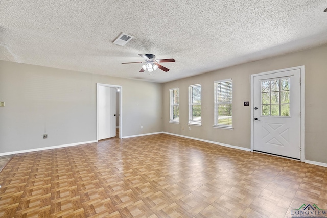 1324 Annette Dr, Longview, TX 75604 - spare room featuring ceiling fan, baseboards, and a textured ceiling