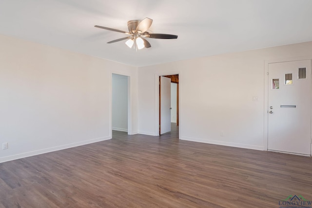 empty room featuring ceiling fan and dark wood-type flooring