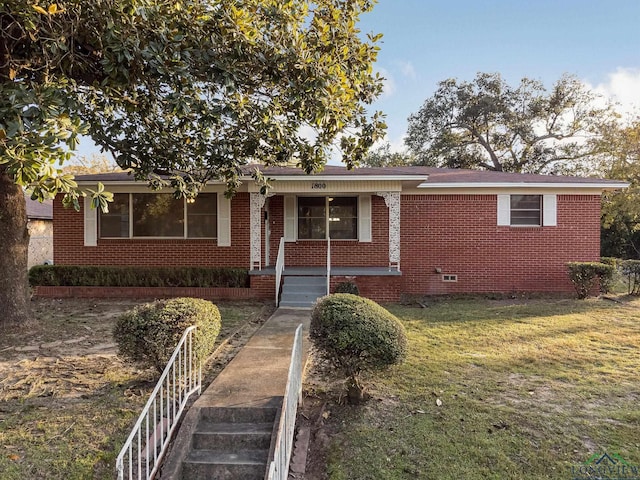 ranch-style home with a front lawn and a porch