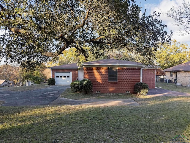 ranch-style home with a garage and a front lawn