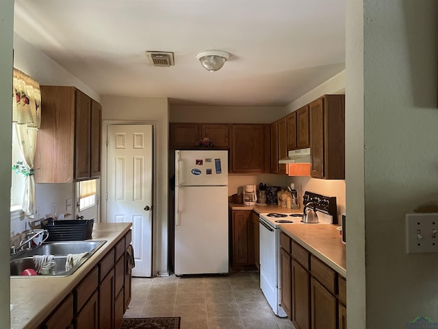 719 N Court St, Longview, TX 75601 - kitchen featuring light tile patterned flooring, white appliances, and sink