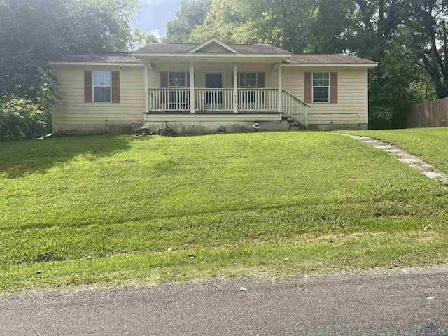 719 N Court St, Longview, TX 75601 - ranch-style home with a porch and a front yard