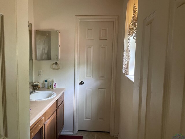719 N Court St, Longview, TX 75601 - bathroom featuring tile patterned floors and vanity