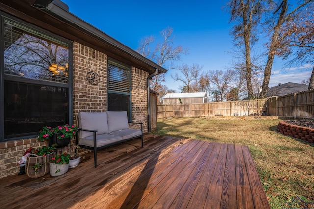 wooden terrace featuring a lawn