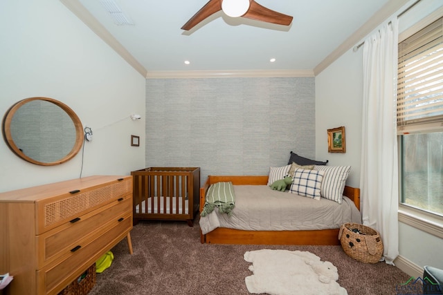 carpeted bedroom featuring ceiling fan and crown molding