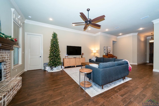 living room with a fireplace, dark hardwood / wood-style floors, ceiling fan, and ornamental molding