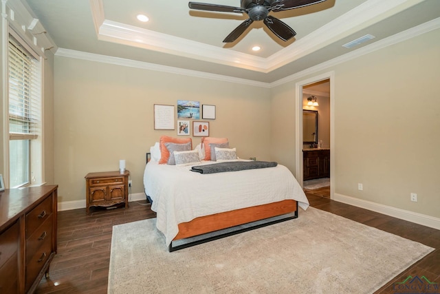 bedroom featuring connected bathroom, a raised ceiling, ceiling fan, and ornamental molding