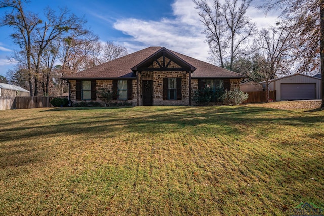 view of front of home featuring a front lawn, an outdoor structure, and a garage