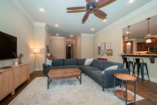 living room featuring ceiling fan, crown molding, and hardwood / wood-style flooring