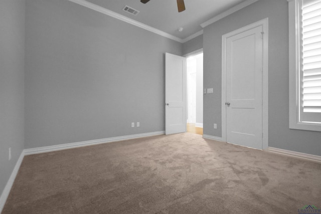 unfurnished bedroom with carpet flooring, ceiling fan, and crown molding