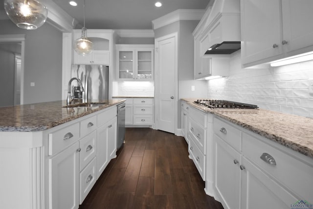 kitchen with custom exhaust hood, hanging light fixtures, an island with sink, appliances with stainless steel finishes, and white cabinetry