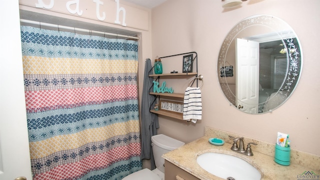 bathroom with vanity, a shower with shower curtain, and toilet