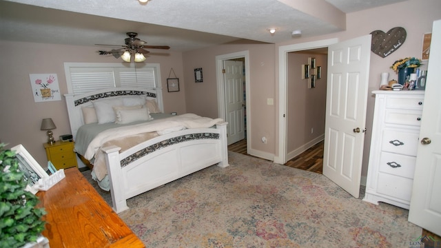 bedroom with a textured ceiling and ceiling fan