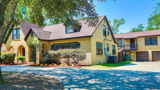 view of front of house featuring a garage and central AC unit