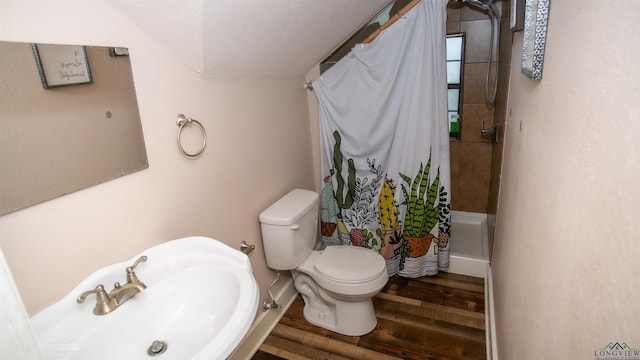 bathroom with a shower with curtain, sink, hardwood / wood-style flooring, toilet, and a textured ceiling