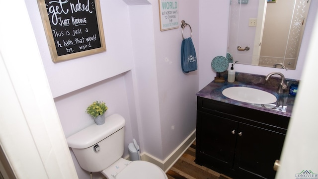 bathroom featuring hardwood / wood-style floors, vanity, and toilet