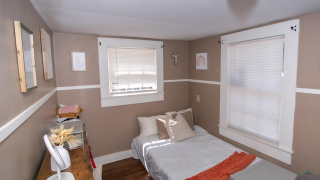 bedroom with dark wood-type flooring