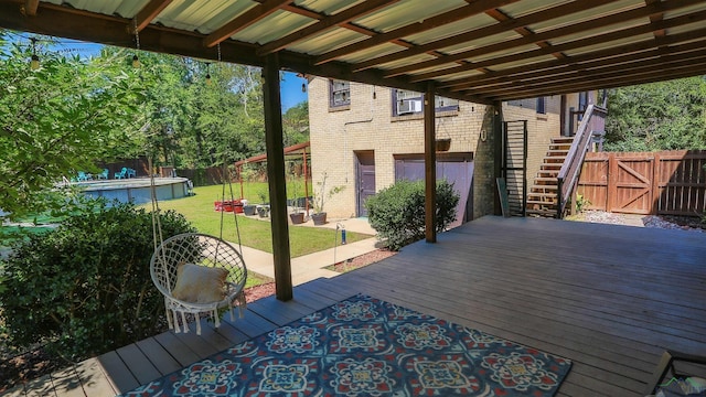 wooden terrace with a yard and a patio