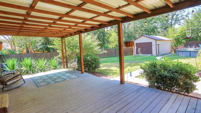 wooden terrace with a lawn and a storage unit