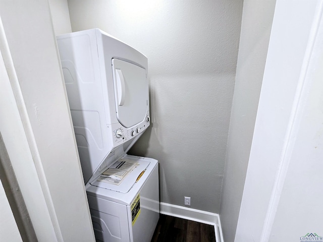 605 E Rusk St, Marshall, TX 75670 - clothes washing area featuring stacked washer / drying machine, baseboards, and dark wood-type flooring