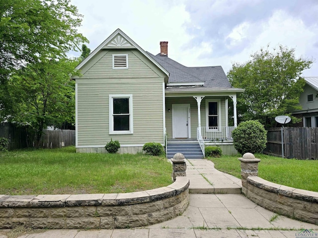 605 E Rusk St, Marshall, TX 75670 - view of front facade featuring a porch, a chimney, and a shingled roof