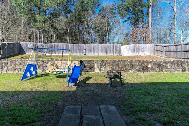 167 Labrador Ln, Hallsville, TX 75650 - view of yard featuring an outdoor fire pit, a fenced backyard, and a playground