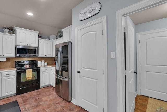 167 Labrador Ln, Hallsville, TX 75650 - kitchen with decorative backsplash, white cabinets, appliances with stainless steel finishes, and light countertops