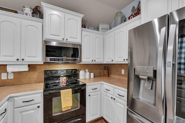 167 Labrador Ln, Hallsville, TX 75650 - kitchen with white cabinetry, light countertops, backsplash, and stainless steel appliances