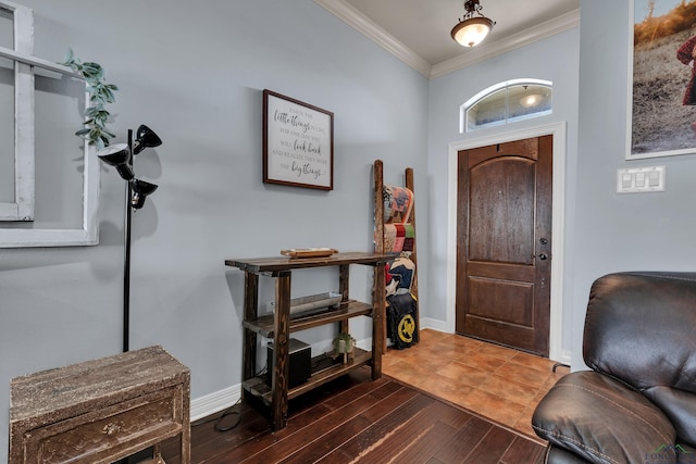 foyer with baseboards, wood finished floors, and ornamental molding